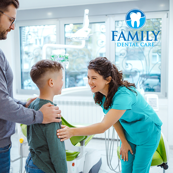 Dentist greeting child and adult