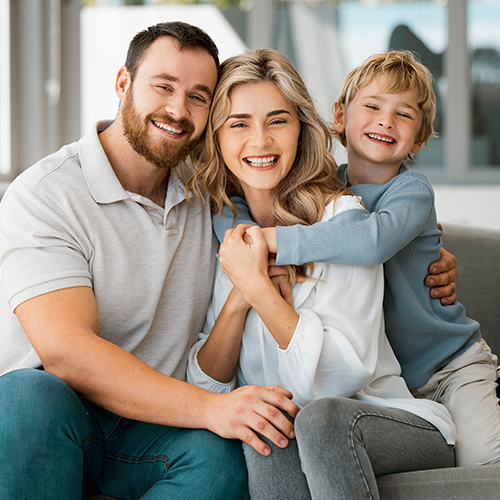 Smiling family sitting together indoors