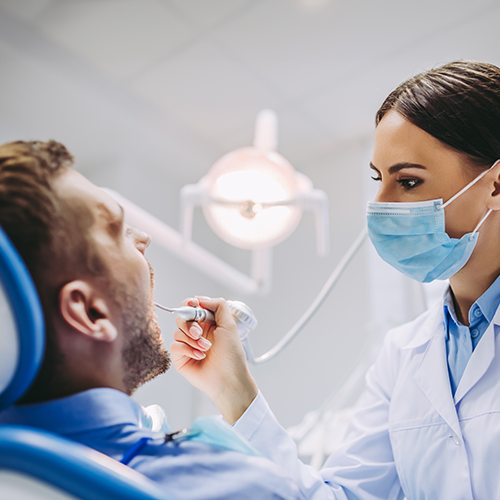 Dentist examining patients teeth