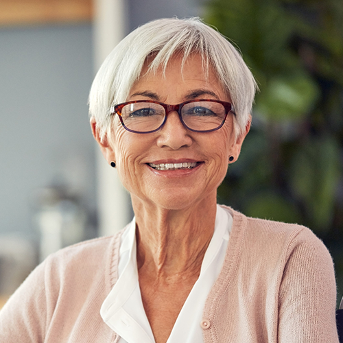 Smiling woman wearing glasses indoors